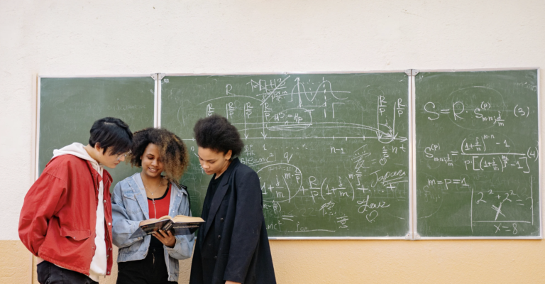 3 Kids Doing Math at Chalkboard